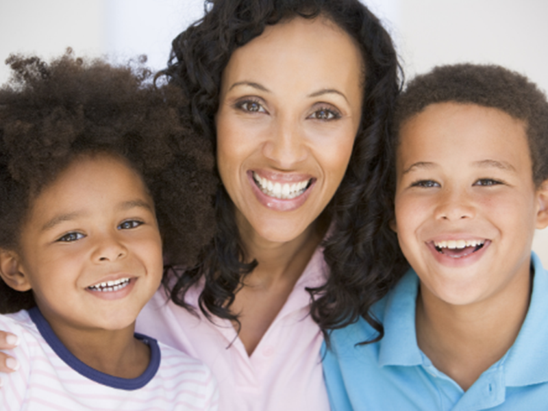 woman with two children, smiling
