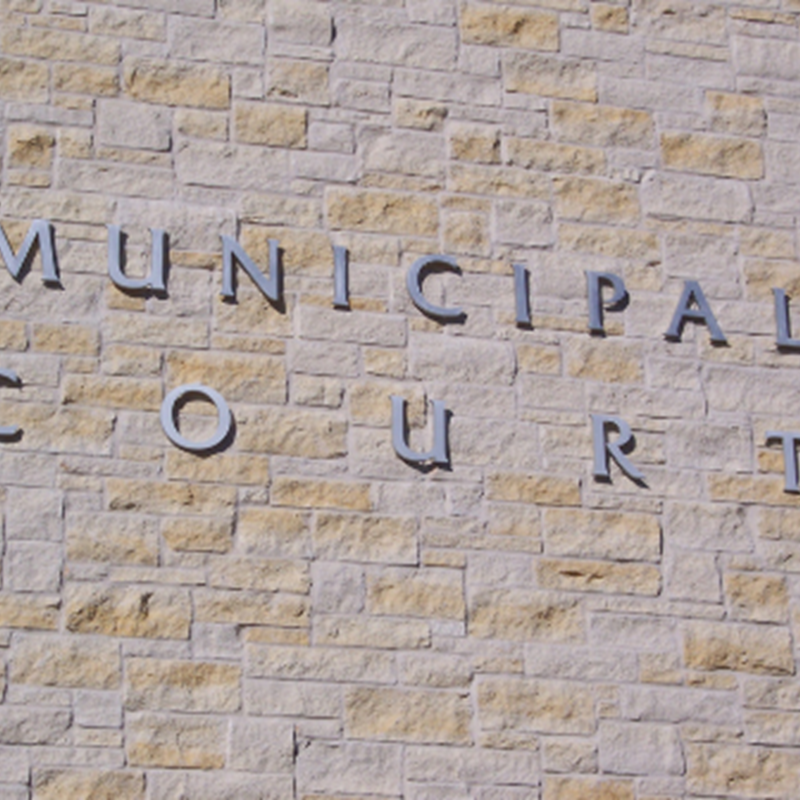 brick wall with "MUNICIPAL COURT" sign